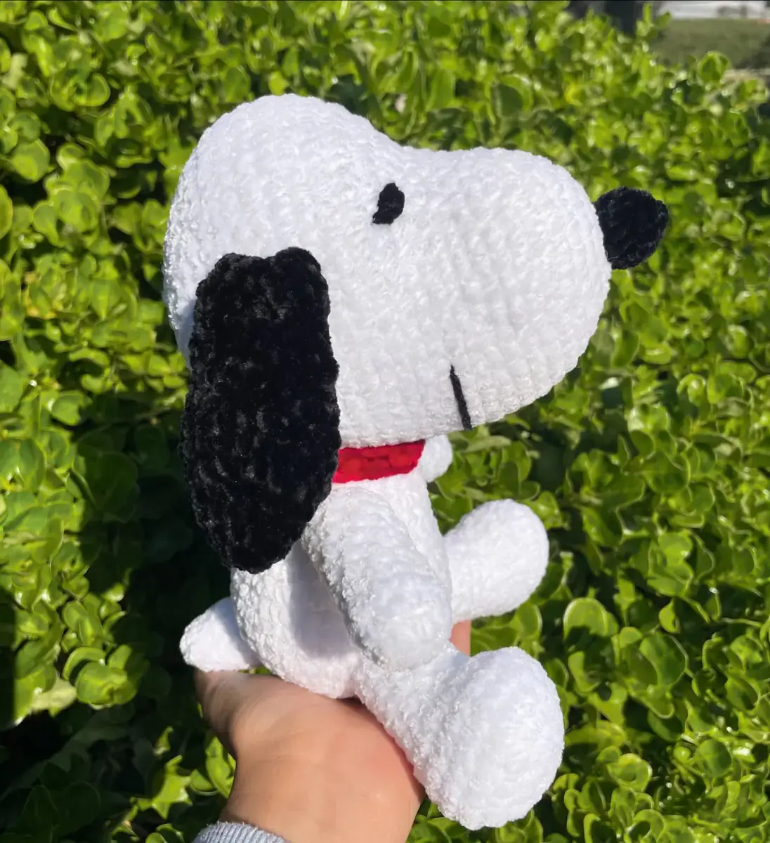 Snoopy blanco tejido sostenido en la mano